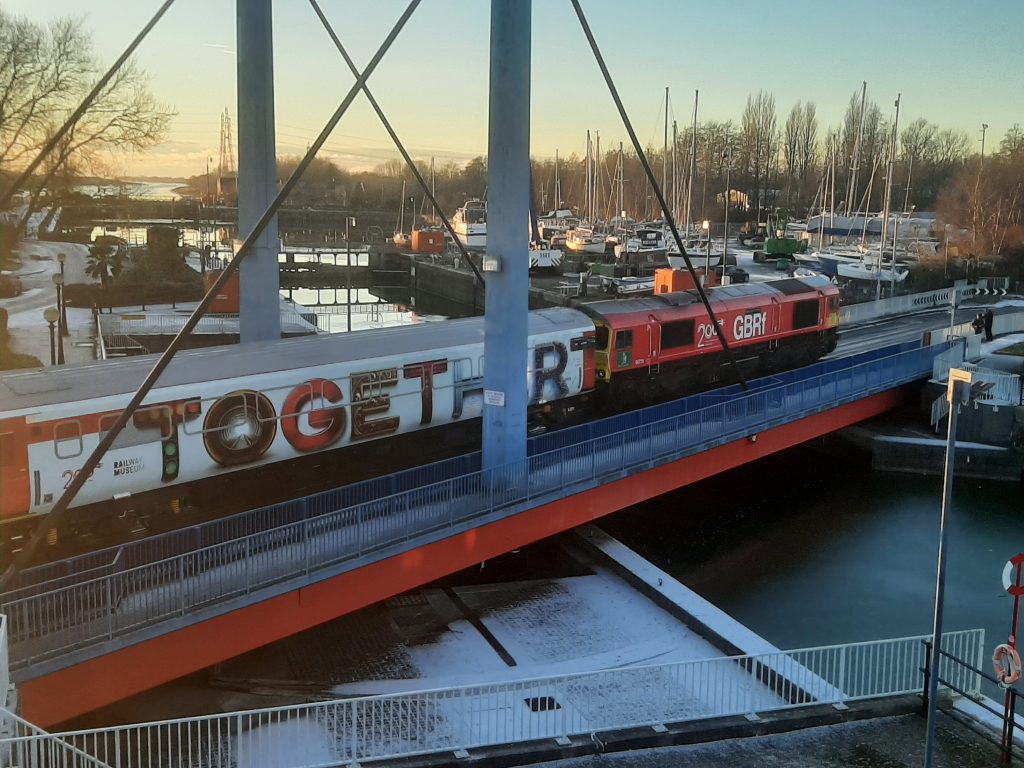 66 719 Michael Portillo hauls the Railway 200 Inspiration Train across the road/rail swing bridge at Preston Docks