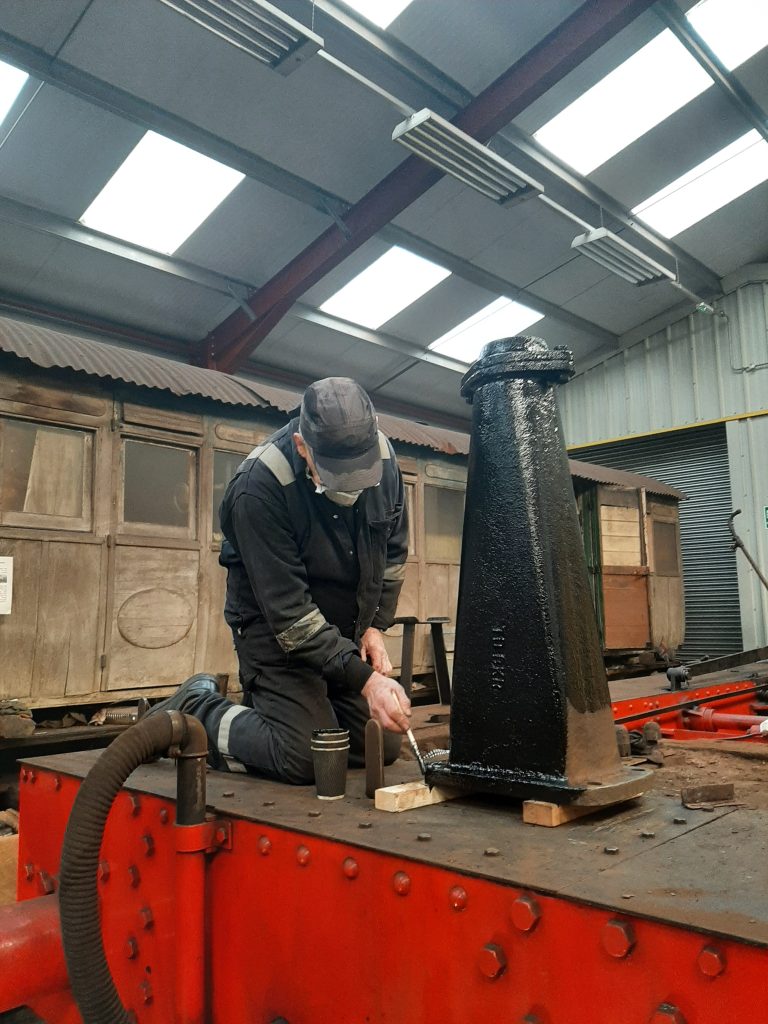 Ron painting Cumbria's newly cleaned blast pipe