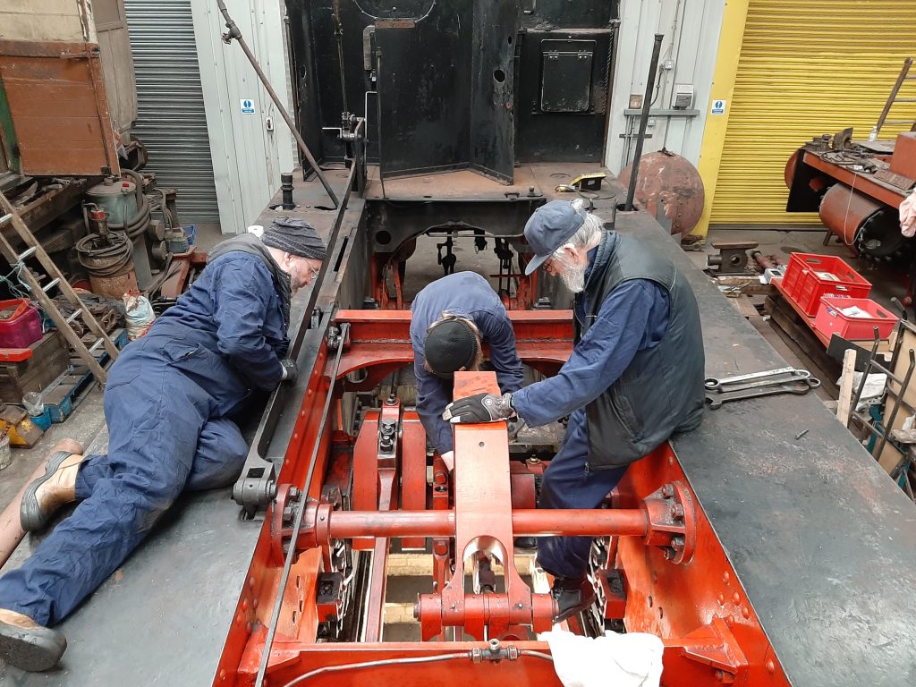Dave Thomas, Anthony Fisher and Alan Middleton working to dismantle Cumbria's eccentric straps