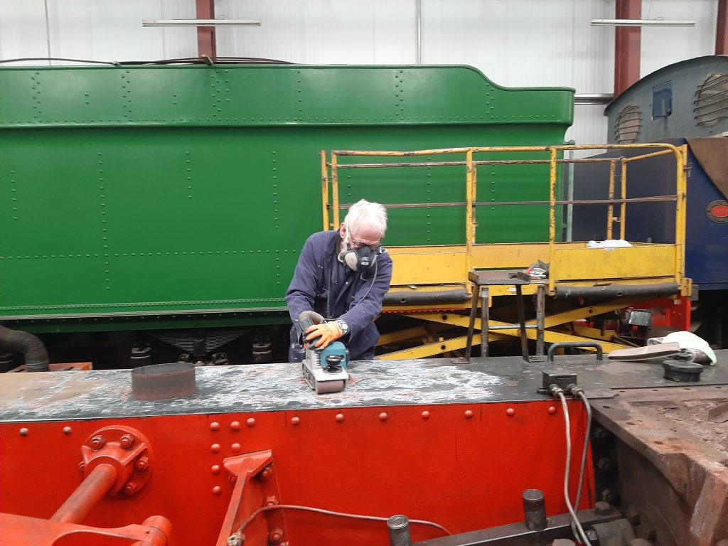 Sim Lane-Dixon uses a belt sander to clean up Cumbria's running boards