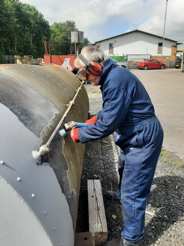Paul Balshaw cleans off old paint from FR 25's saddletank.