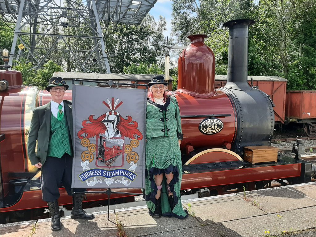 Two members of the Furness Steampunkers with their banner