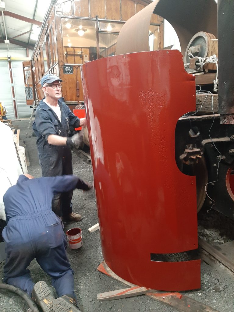 Paul Kelly and Jon Dixon painting Cumbria's boiler cladding plates.
