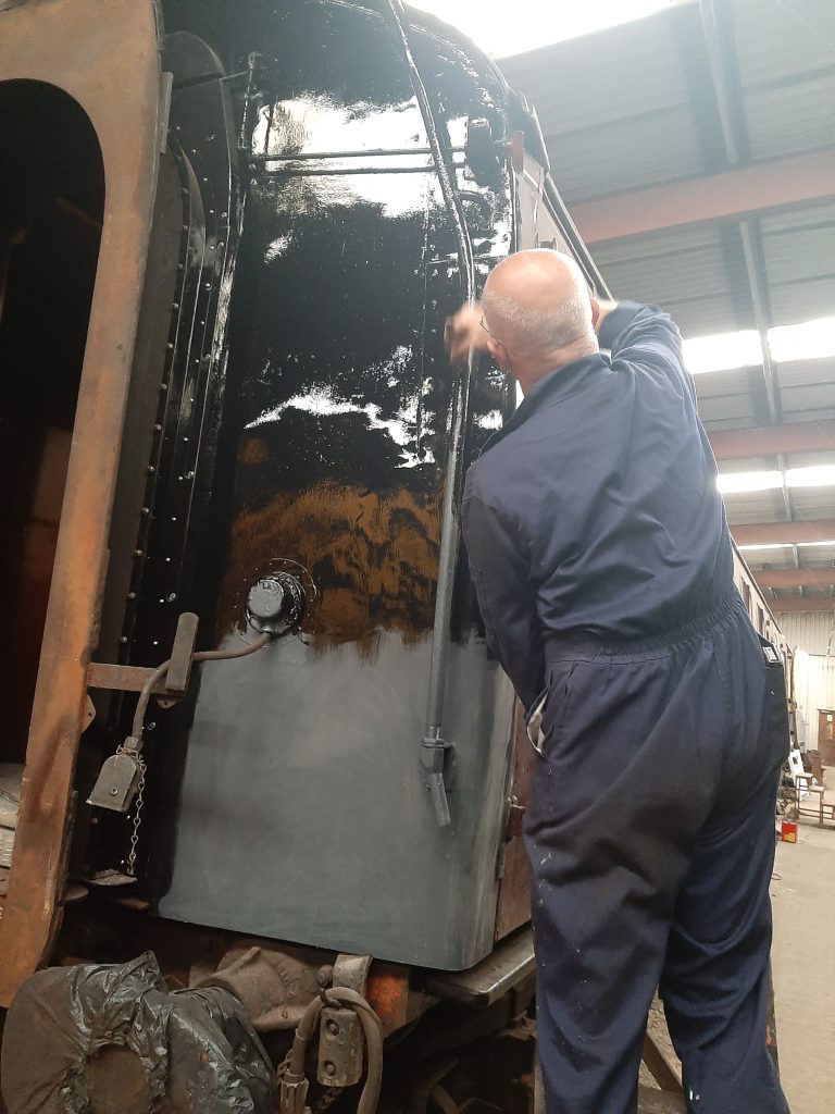 Paul Kelly applying gloss black to the west corridor end of BSK 35128